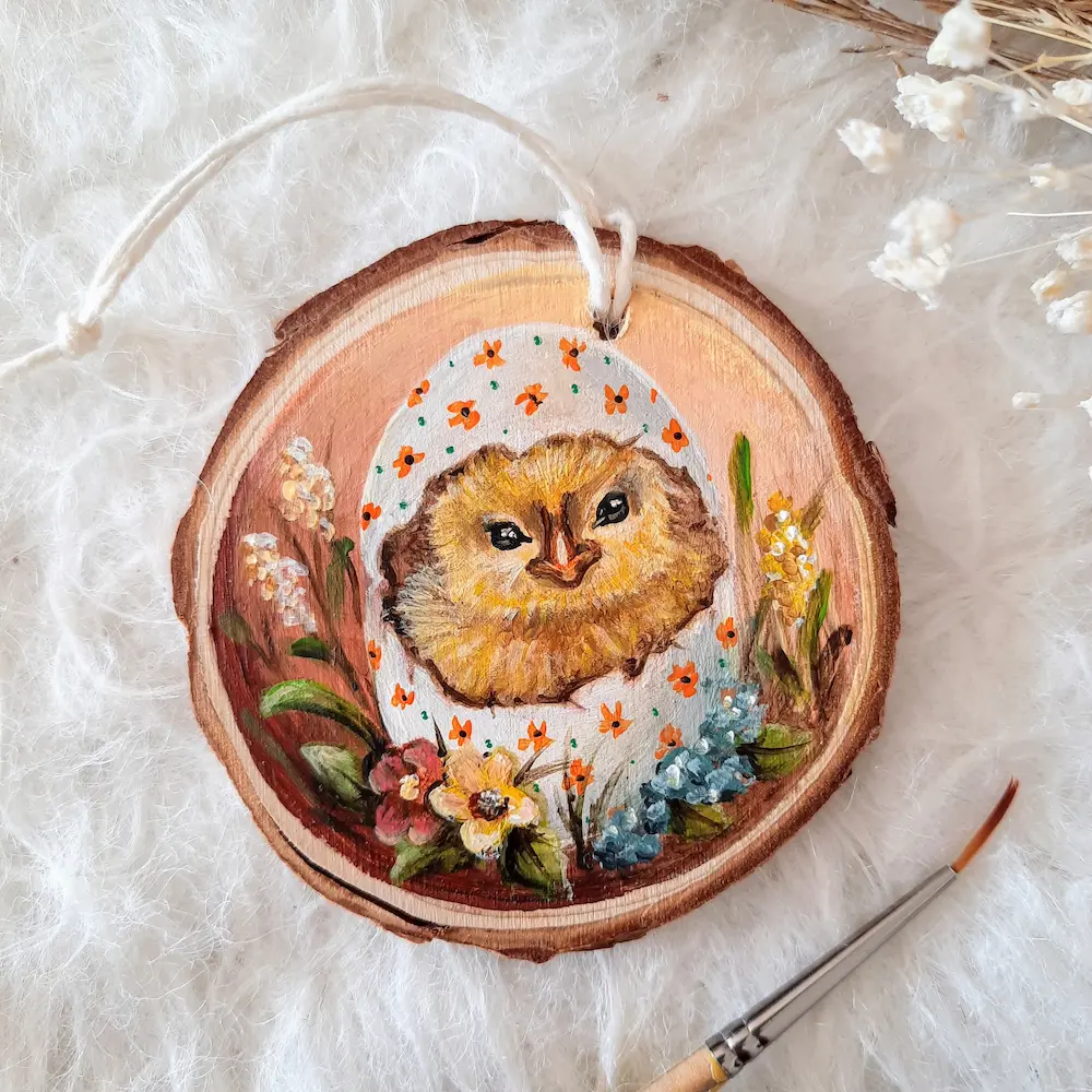 Handpainted treeslice of a babychick hatcing in an easter decorated egg